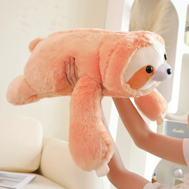 Person holding a large pink sloth plush toy against a neutral background