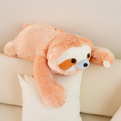 Plush sloth toy on a light-colored couch