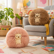 Two round, fluffy hedgehog-shaped poufs or cushions in pink and brown, each with a small teddy bear face in the center, displayed in a cozy, colorful children's room setting.