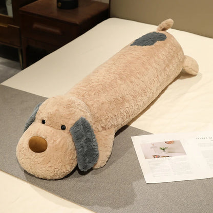 Dog-shaped kawaii plushie body pillow on a bed with a magazine underneath