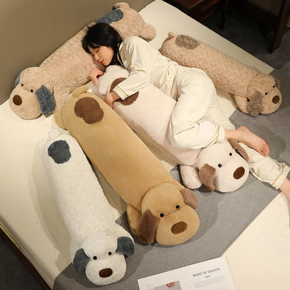 Person lying on a bed with large dog-shaped plushie body pillows