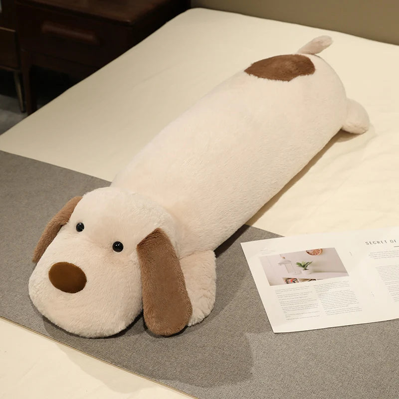 Dog-shaped plushie body pillow on a bed with a magazine underneath