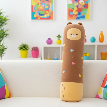 Cylindrical plush toy with bear design on a couch in a colorful room.