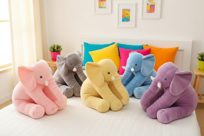 Colorful elephant plush toys on a bed with a bright and cheerful background.