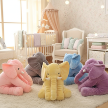 Colorful elephant plush toys in a nursery setting with a crib and chair.