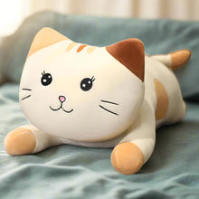 Plush cat toy on a textured surface with a blurred background