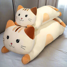 Cat-shaped plushie pillow on a surface with a blurred background