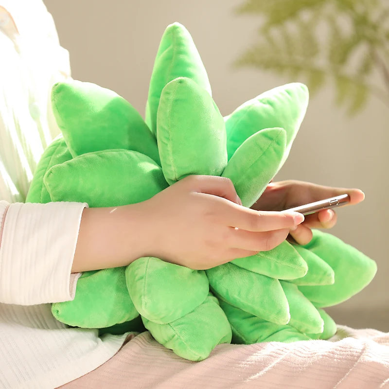 Person holding a green plush plant toy with a phone, on a neutral background