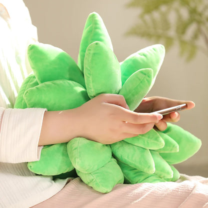 Person holding a green plush plant toy with a phone, on a neutral background