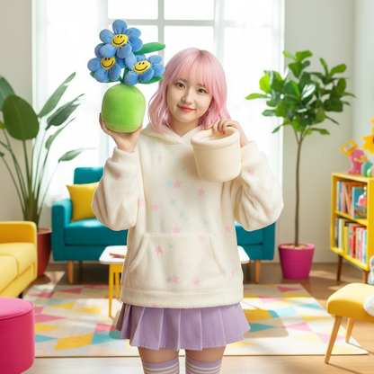 Person with pink hair holding a plush flower pot with smiley face flowers in a colorful room.