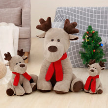 Three plush reindeer toys with red scarves in a living room setting.