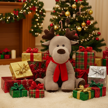 Plush reindeer toy with a red scarf surrounded by Christmas presents and decorations.
