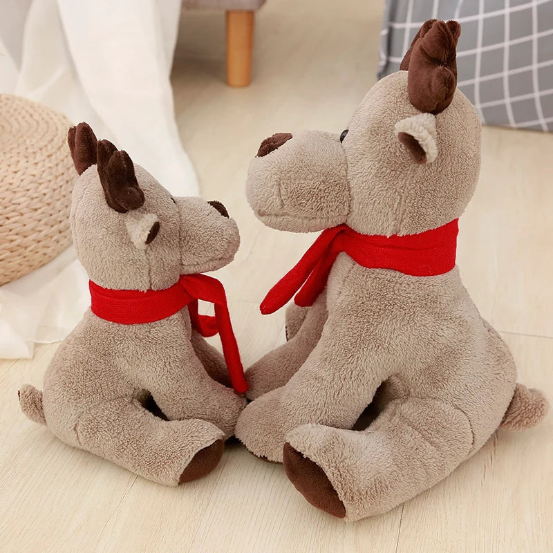 Two plush deer toys with red scarves sitting on a light wooden floor.