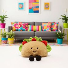 Plush taco toy on a white surface with a colorful living room in the background