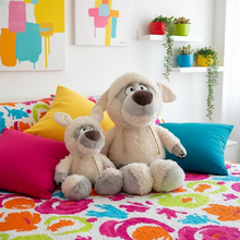 Two plush wolf toys on a colorful bed with abstract art and plants in the background