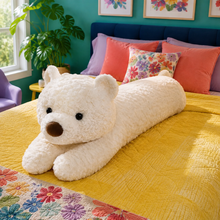 Cloud Cream Bearly Awake teddy bear body pillow on a yellow bed in a bright teal bedroom.