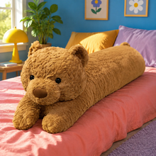 Honey Brown Bearly Awake teddy bear body pillow on a coral bed in a colorful blue bedroom.