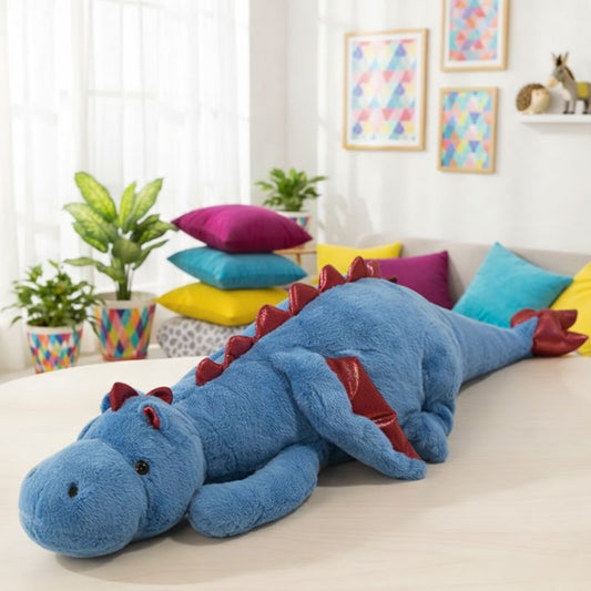 Blue dinosaur plush toy on a couch with colorful pillows in a room with plants and framed art.