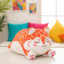 Plush tiger toy on a couch with colorful pillows in the background