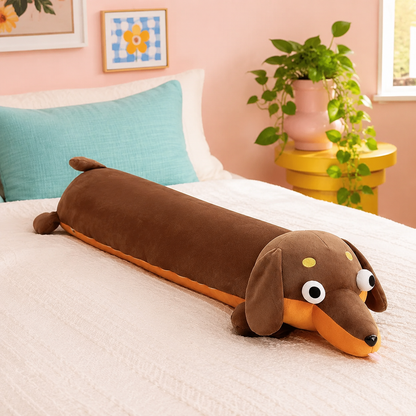 Cocoa brown Daydream Dachshund long body pillow resting on cream bedding in a colorful bedroom.