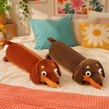 Cinnamon and cocoa brown Daydream Dachshund long body pillows displayed together on a bright bed.