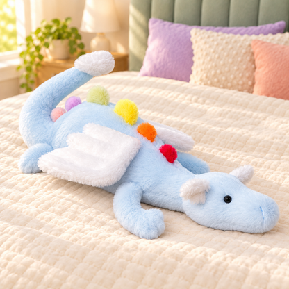 Blue Rainbow Dreamwing dragon plushie with a pale blue body, white wings and rainbow-colored back spikes.