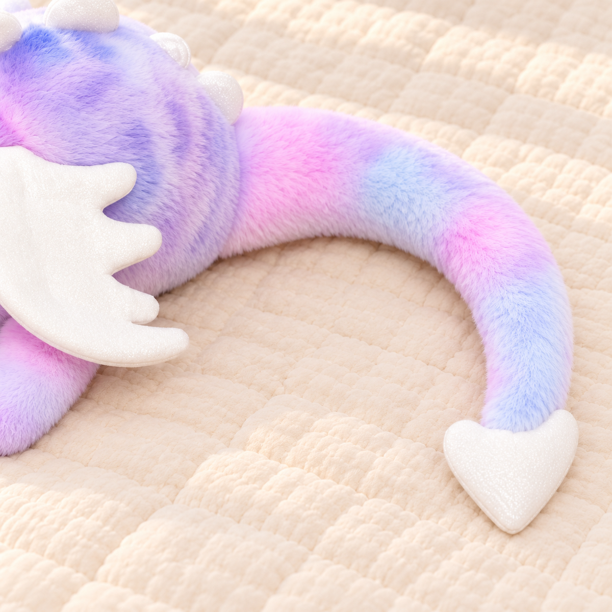 Lavender Tie-Dye Dreamwing dragon showing its curved pastel tail and white heart-shaped tip.