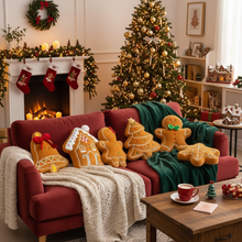 Cozy living room decorated for Christmas with a tree, stockings, and festive plushie pillows.