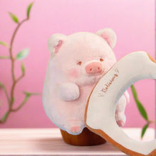Pig plushie pink with bread, side view