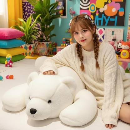 Woman sitting on a bed with a large white teddy bear in a colorful room.