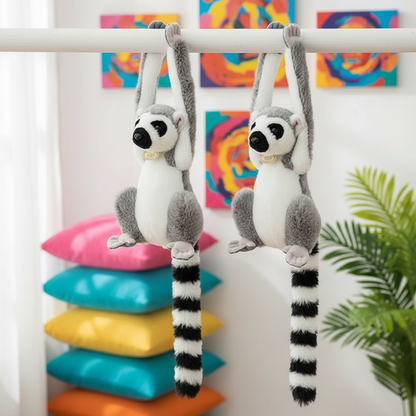 Two plush lemurs hanging from a bar with colorful pillows and abstract art in the background.