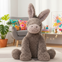 Plush donkey toy in a room with colorful cushions and plants