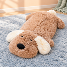 Brown Snuggle Dog Plushie Pillow lying flat with cream floppy ears and a sleepy face